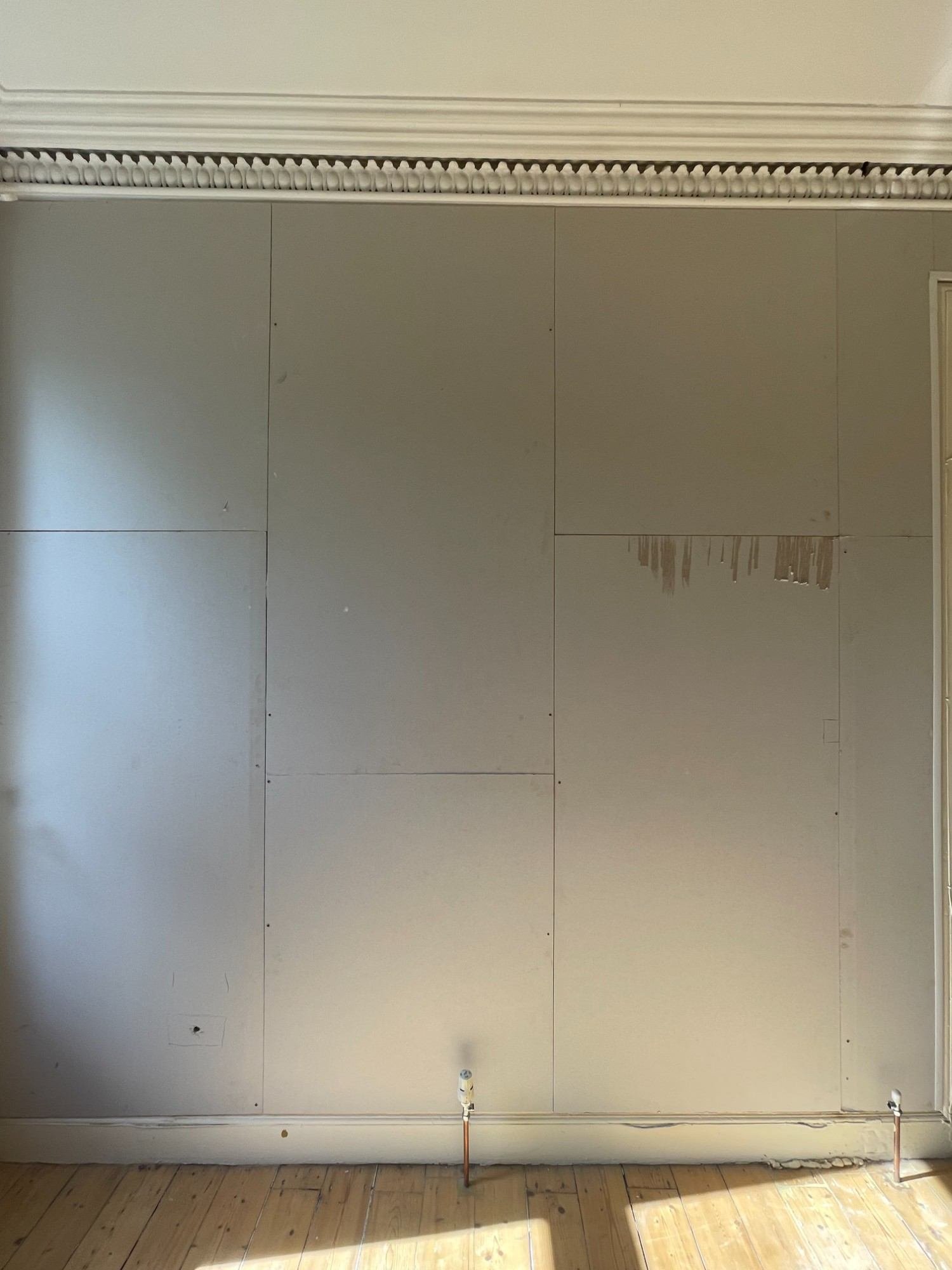 Acoustic plasterboard fitted to bedroom wall to reduce neighbour noise in a Marchmont flat, Edinburgh