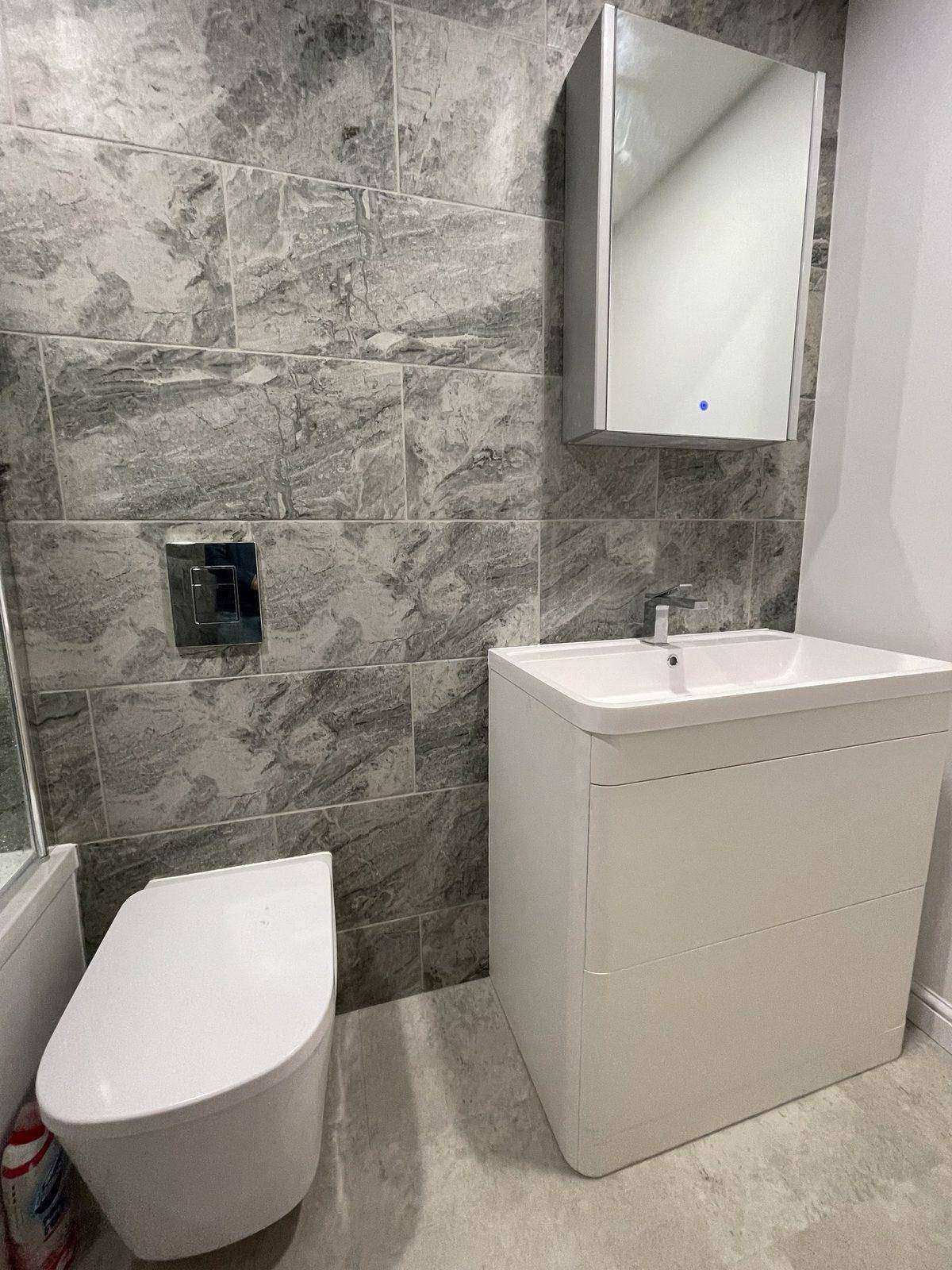 Finished enlarged bathroom with bath and tiled walls in a Marchmont flat, Edinburgh